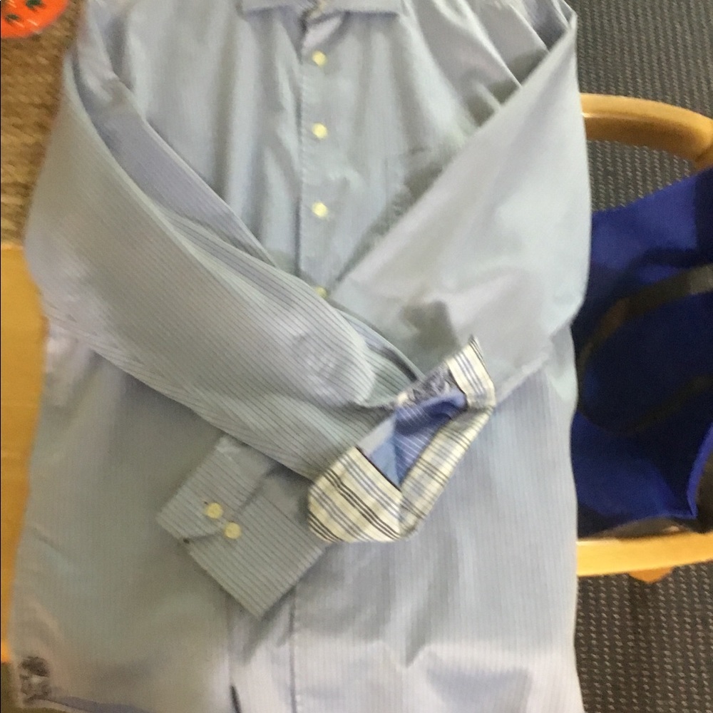 Light blue button up shirt with navy strips going up